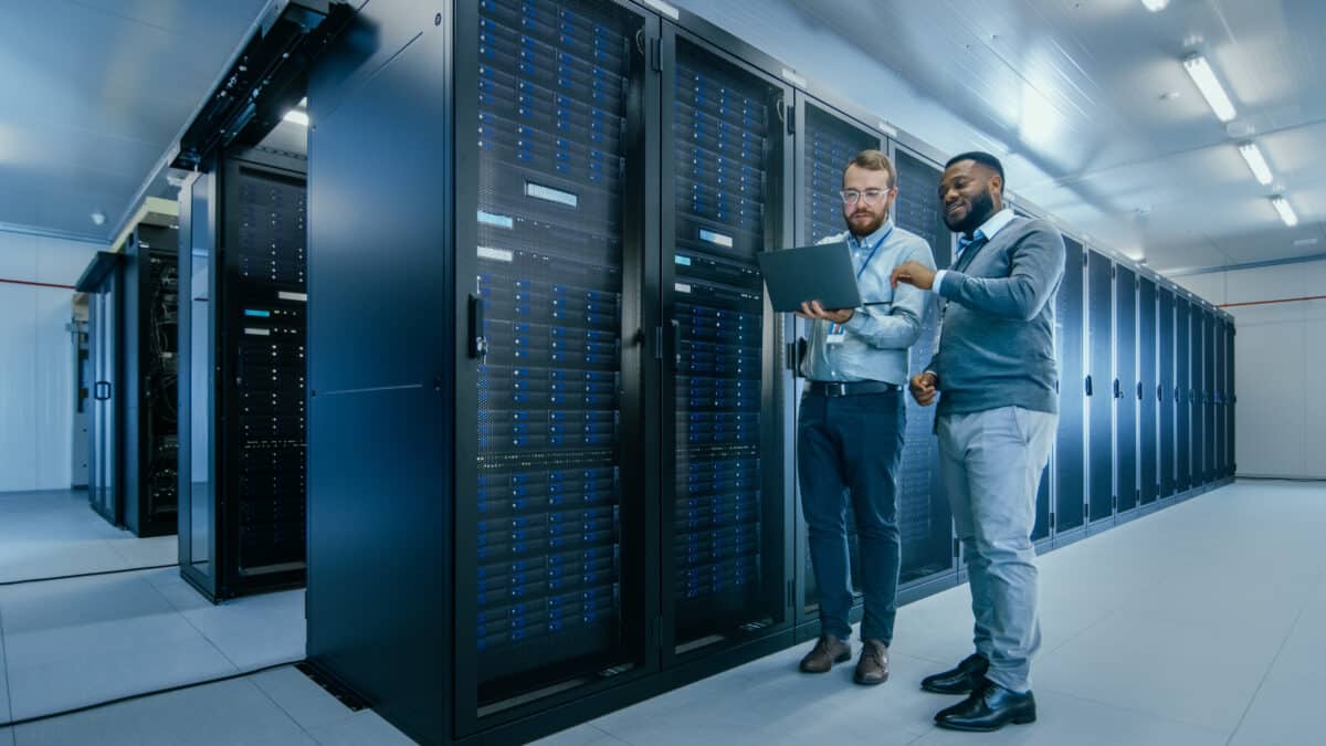 two men standing in a data center